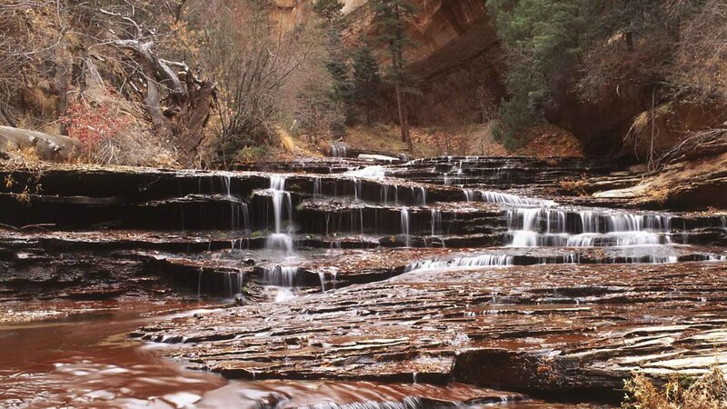 Waterfall cascading over rock layers