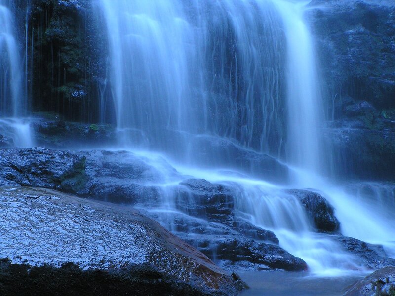 Waterfall Cascading over Rocks — Blue, Serene, Photograph, Forest