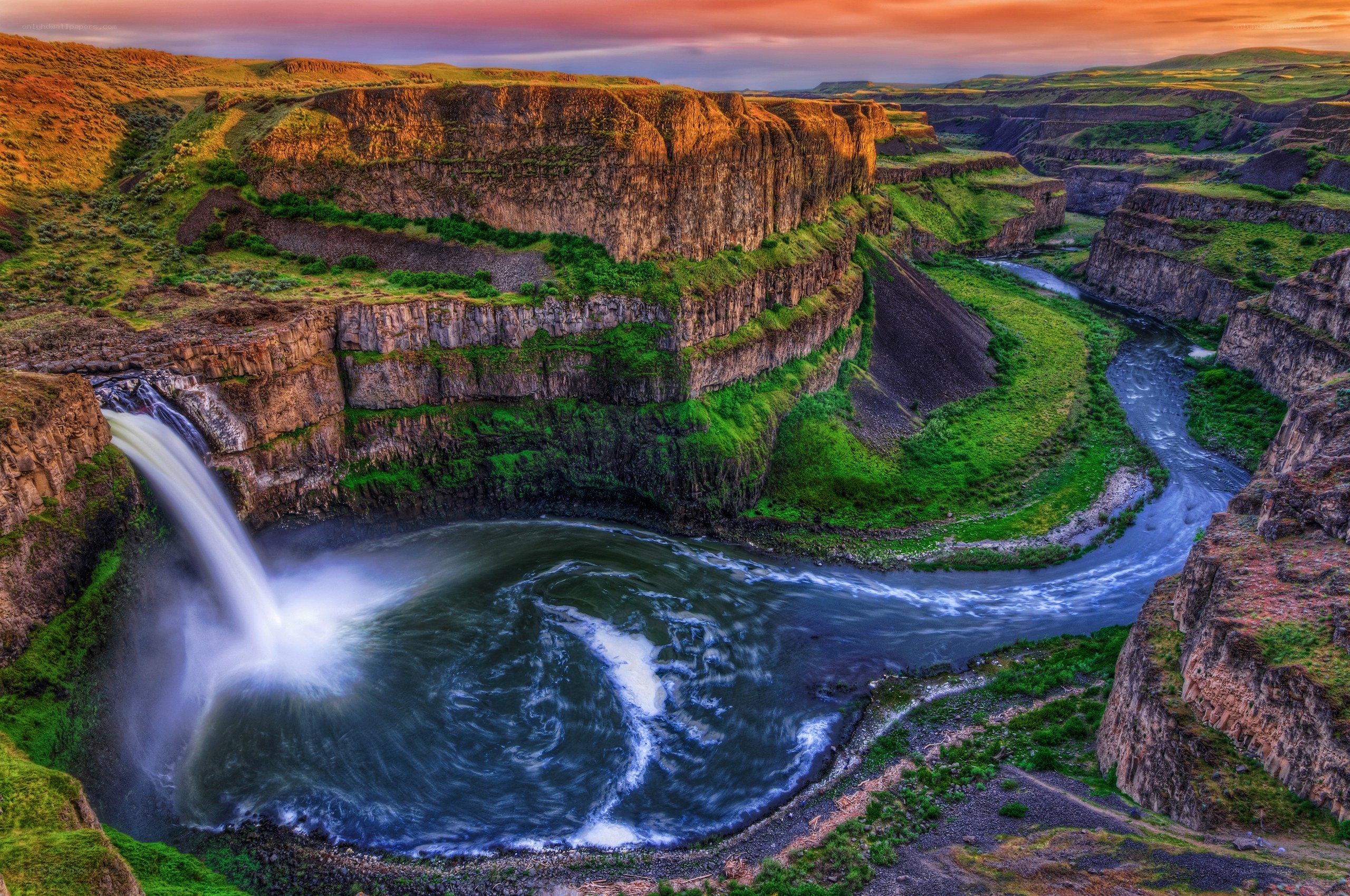 Waterfall in a canyon at sunset