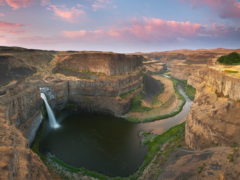 Waterfall in a canyon at sunset