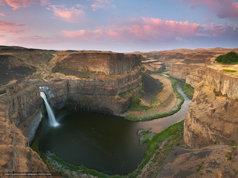 Waterfall in a canyon at sunset
