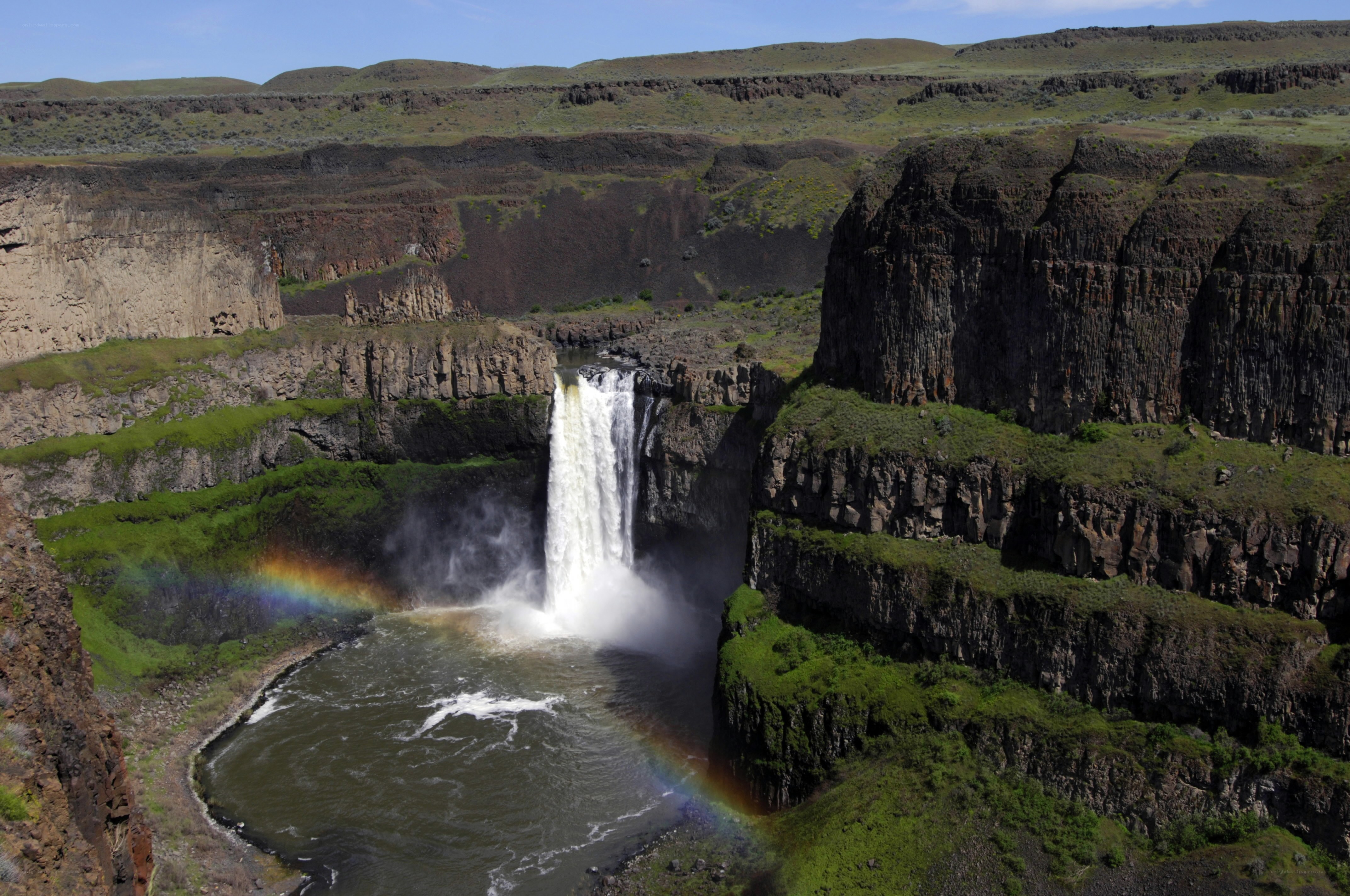 Waterfall in a canyon with rainbow