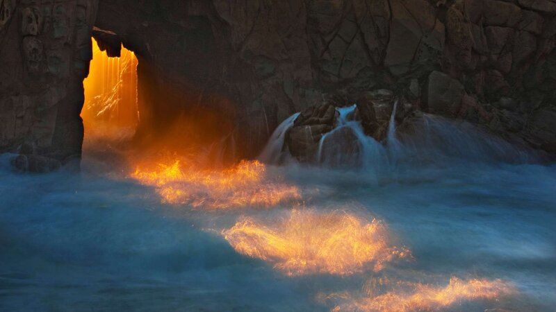 Waterfall in a cave at sunset