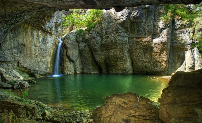 Waterfall in a cave pool