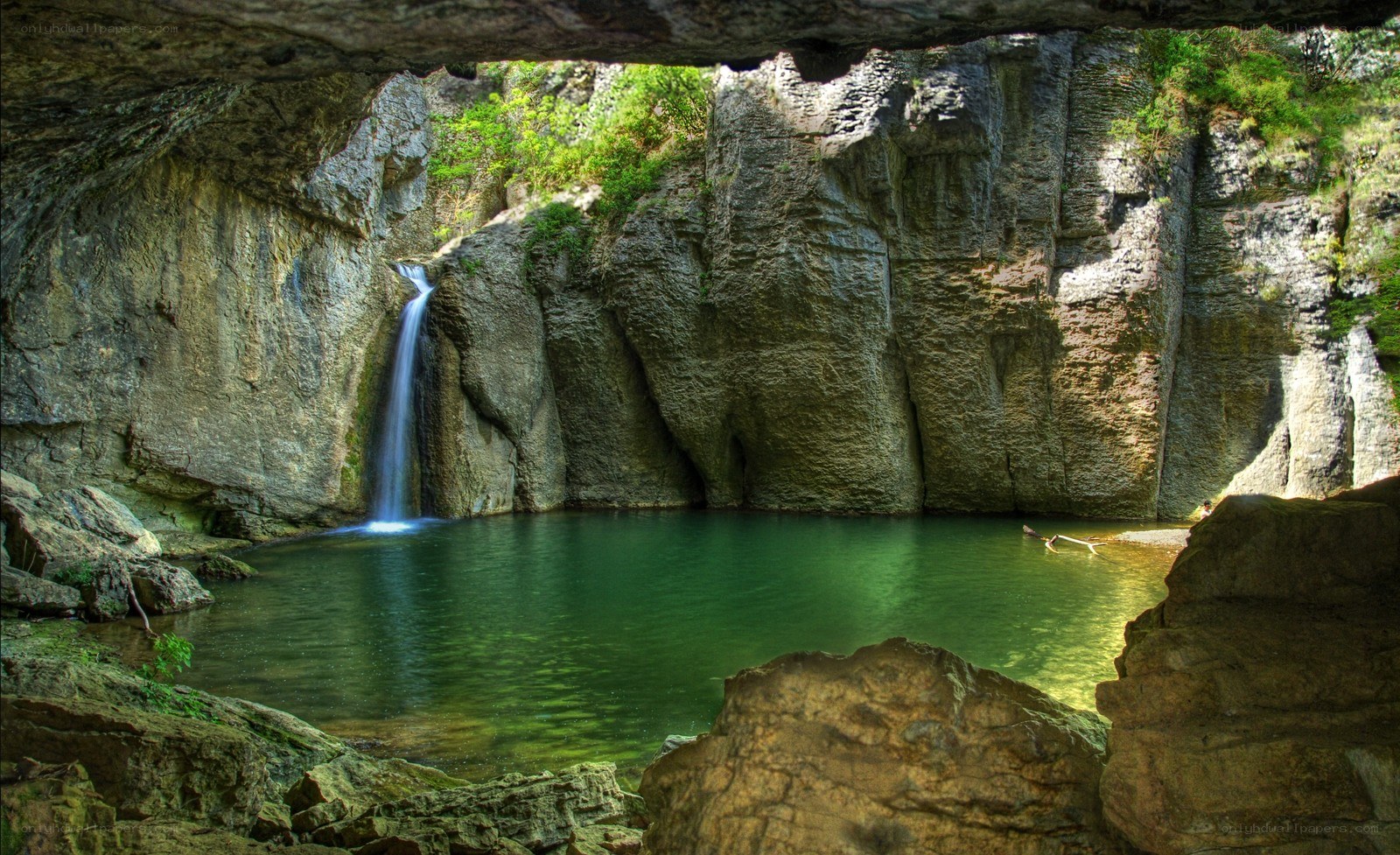 Waterfall in a cave pool