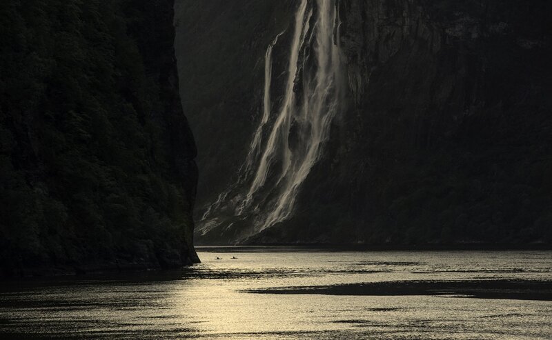 Waterfall in a fjord at dusk