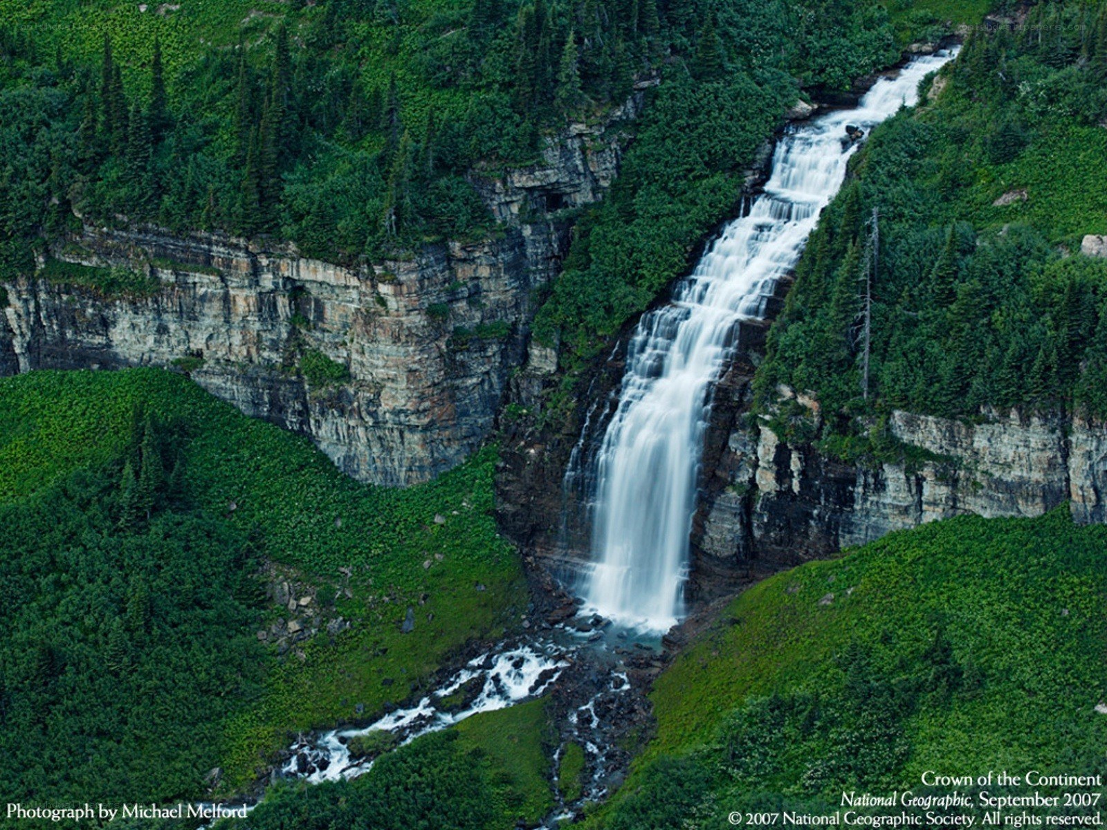 Waterfall in a forested canyon