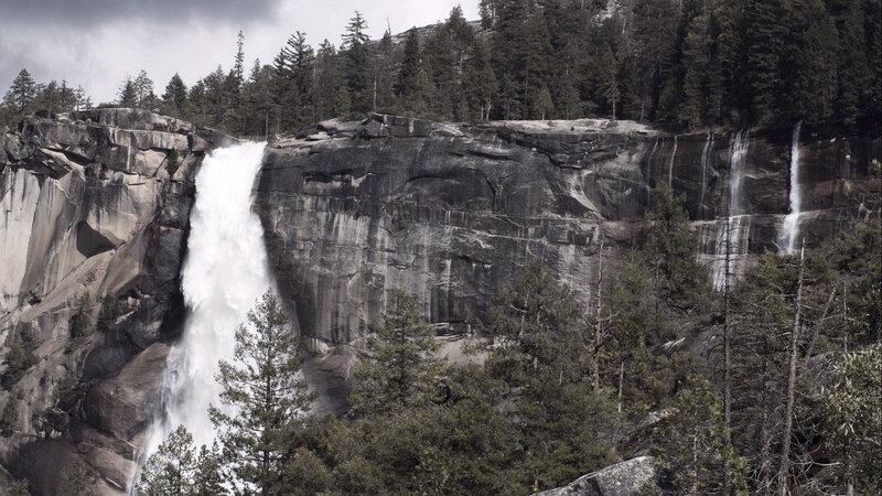 Waterfall in a forested canyon