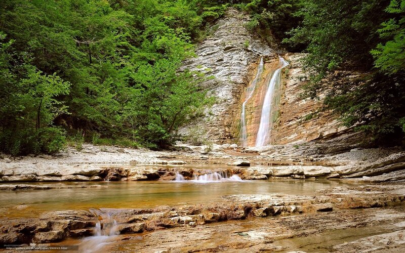 Waterfall in a forested valley