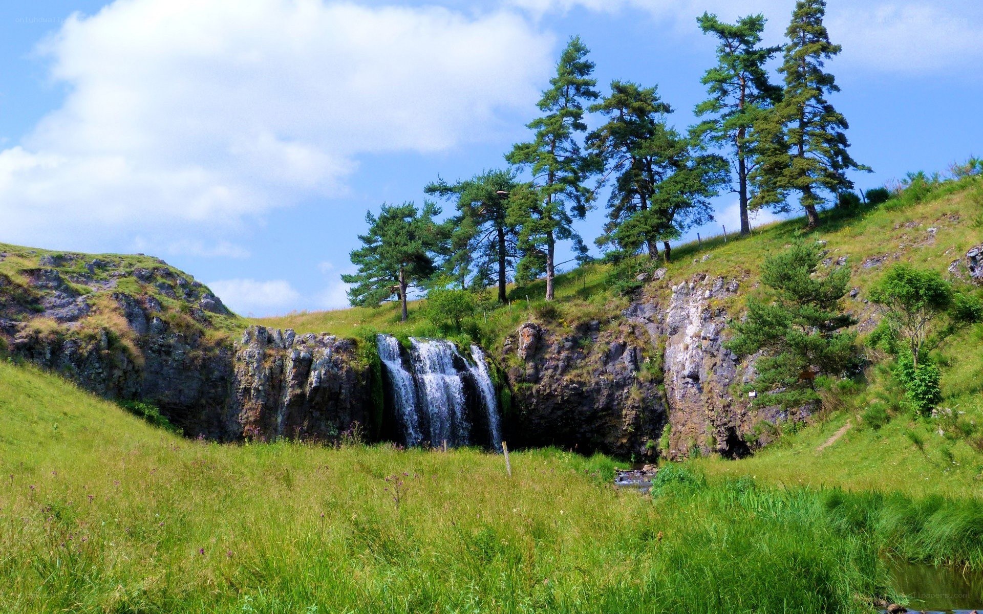 Waterfall in a grassy valley