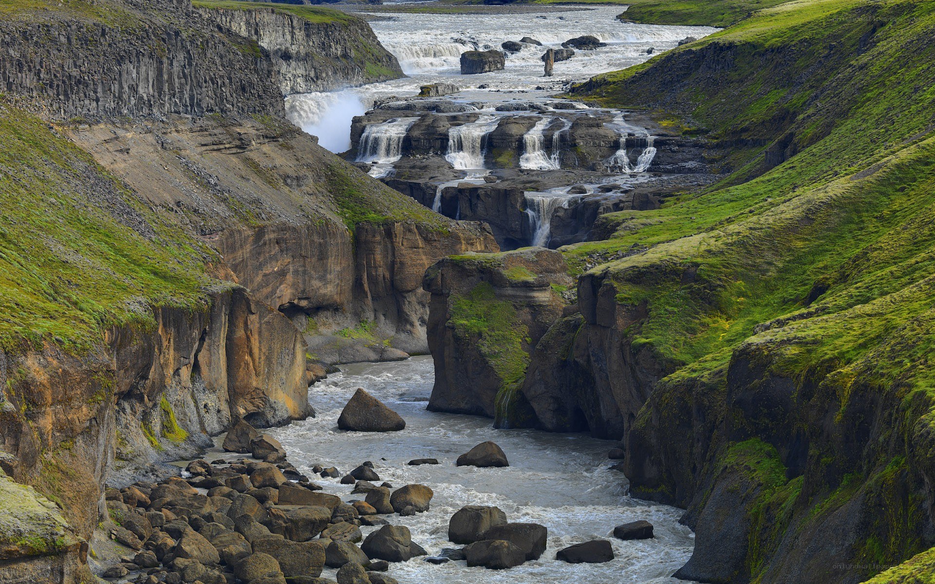 Waterfall in a green canyon