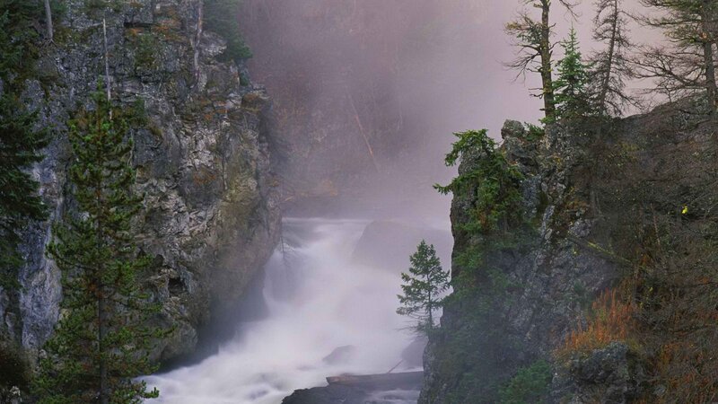 Waterfall in a misty canyon