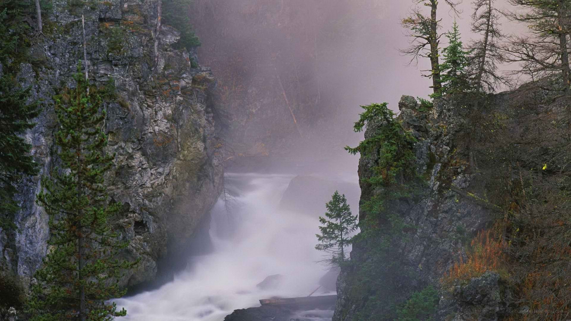 Waterfall in a misty canyon