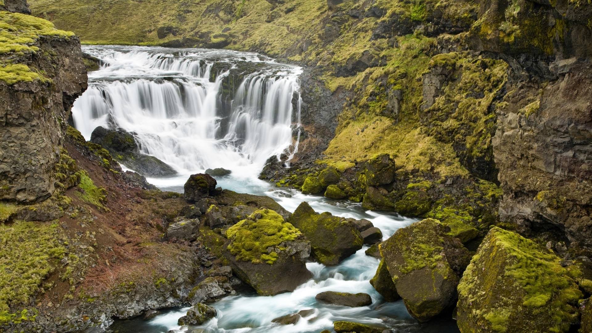 Waterfall in a mossy canyon