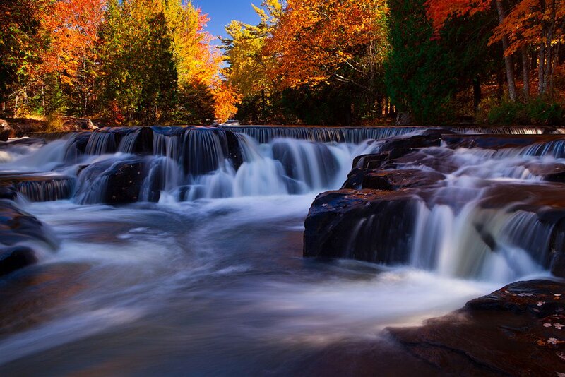Waterfall in Autumn Forest — Orange, Serene, Photograph, Trees, River, Rocks, Fallen Leaves