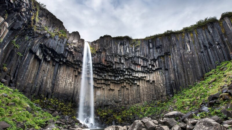 Waterfall in Basalt Cliffs — Black, Dramatic, Photograph