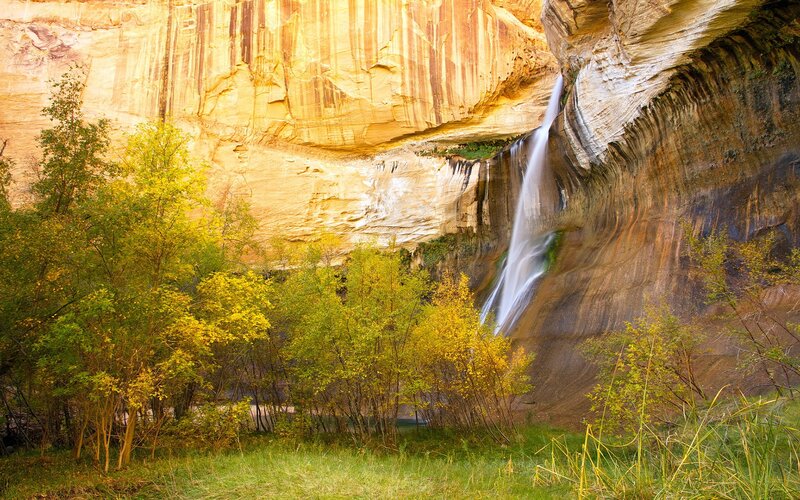 Waterfall in canyon with autumn trees