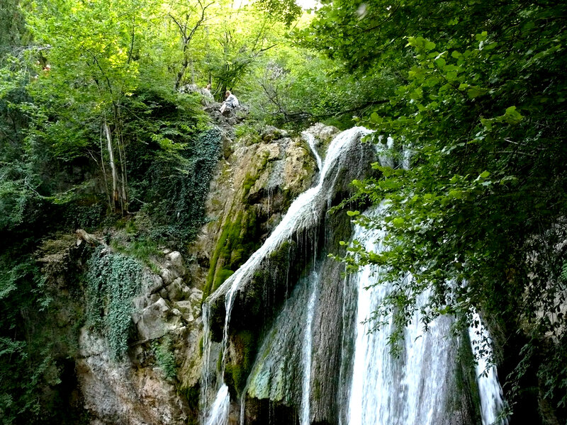 Waterfall in Forest — Green, Serene, Afternoon, Photograph, Trees, Rocks, People