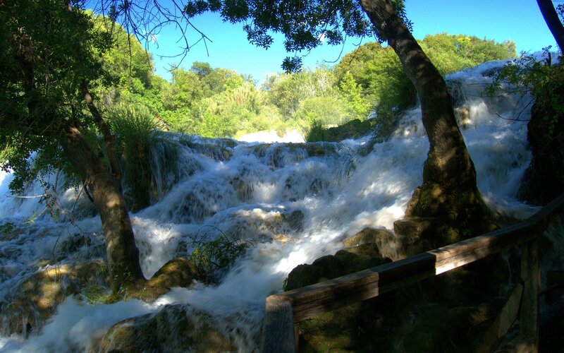 Waterfall in Forest — Green, Serene, Afternoon, Photograph, Trees, Rocks, Wooden Railing, Blue