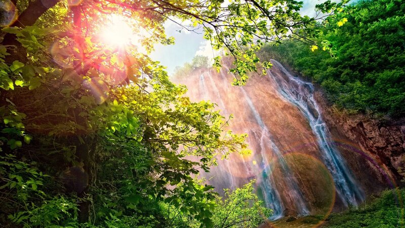 Waterfall in Forest — Green, Serene, Afternoon, Photograph, Trees, Sunlight, Rainbow, Blue, Brown