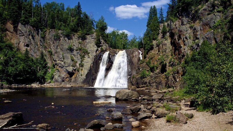 Waterfall in forested canyon