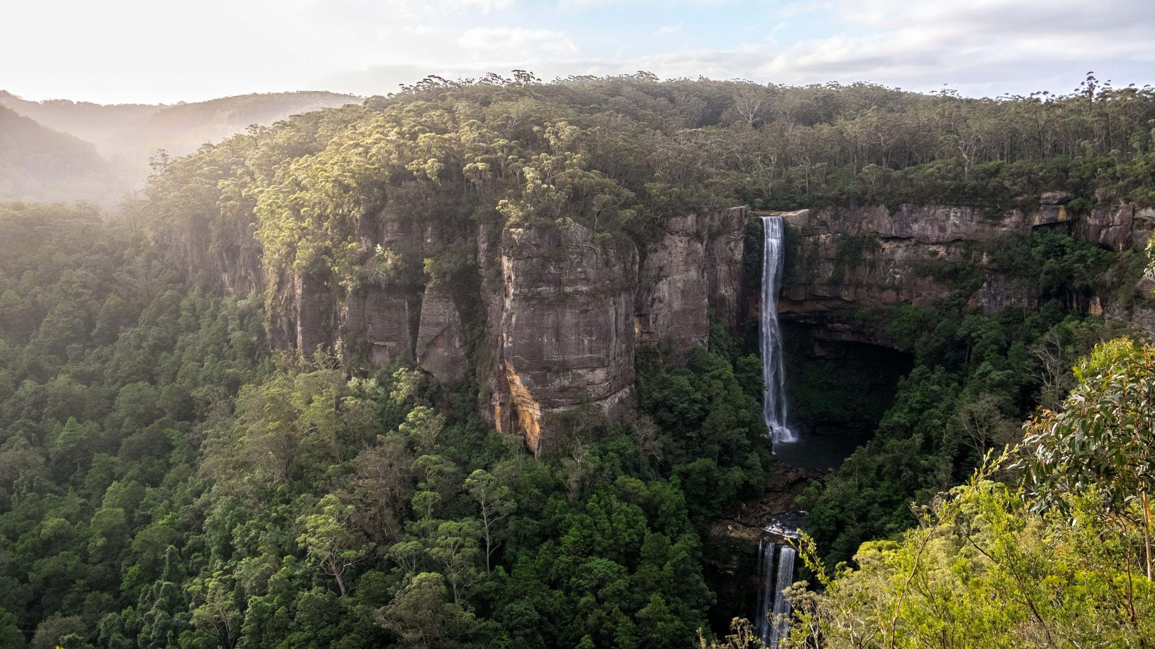 Waterfall in forested canyon