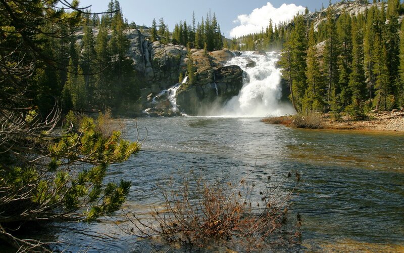 Waterfall in forested mountains
