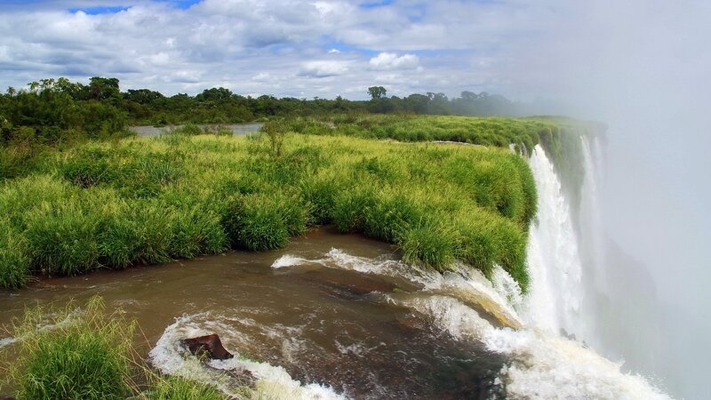 Waterfall in Grassy Landscape