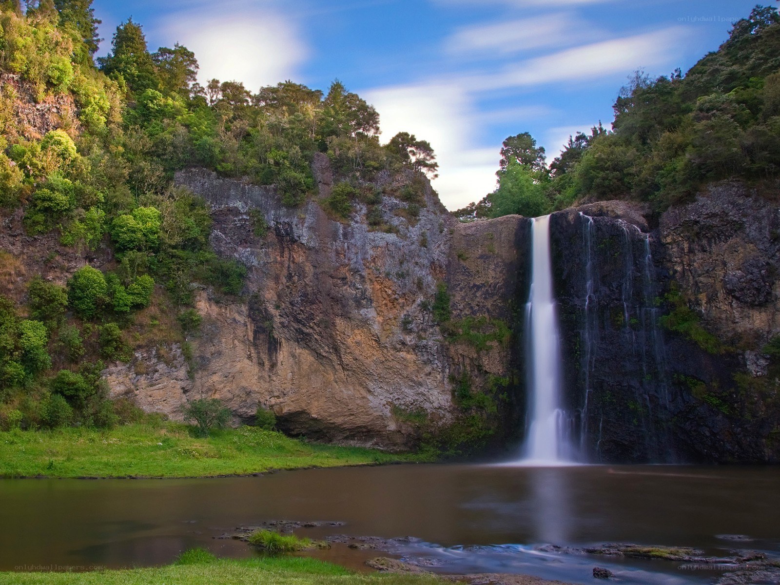 Waterfall in lush green landscape