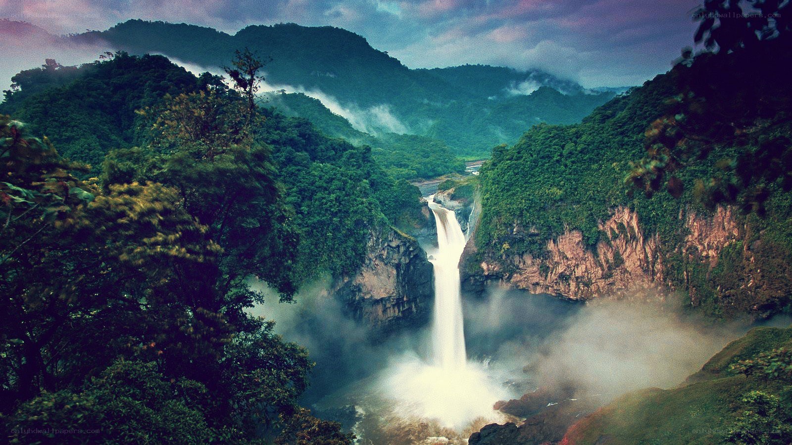 Waterfall in lush green mountains