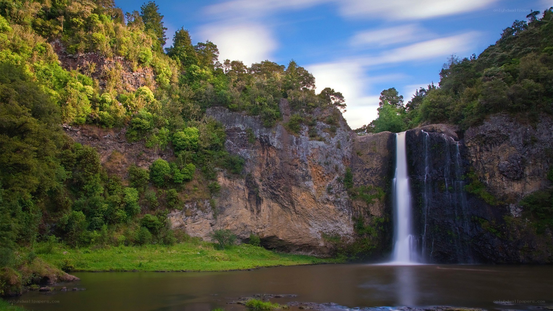 Waterfall in lush green valley