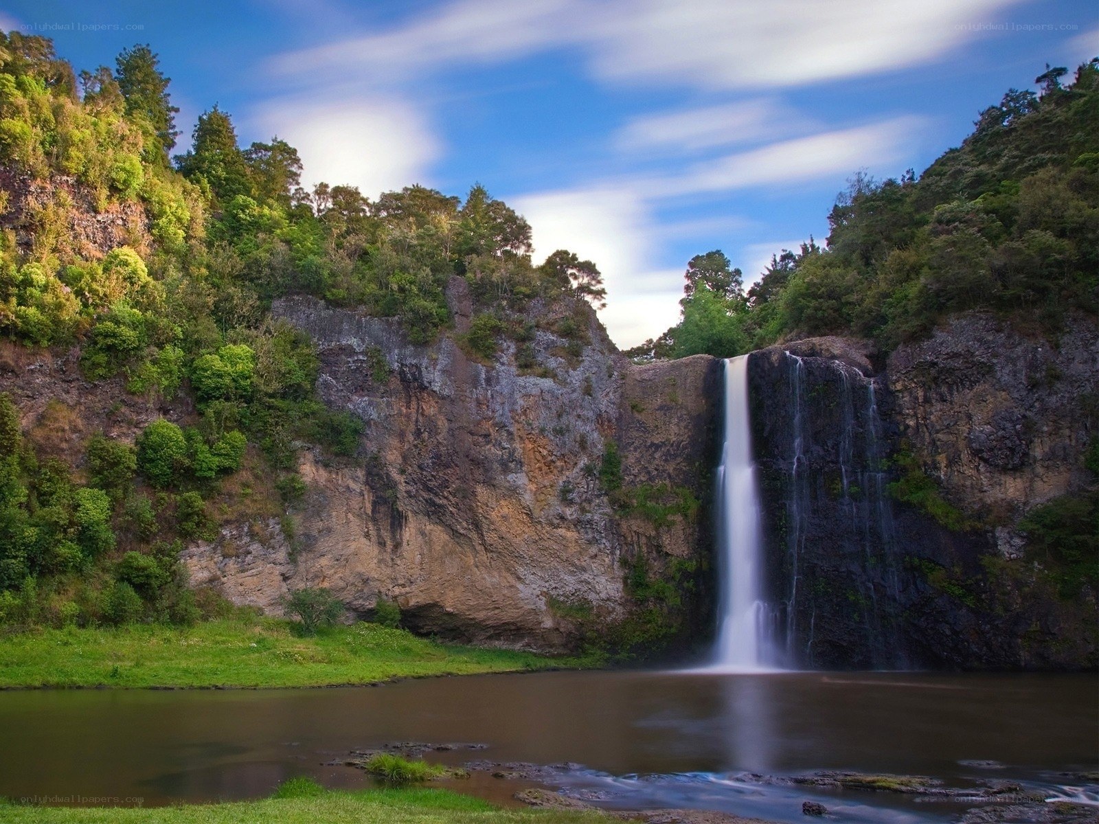 Waterfall in lush green valley