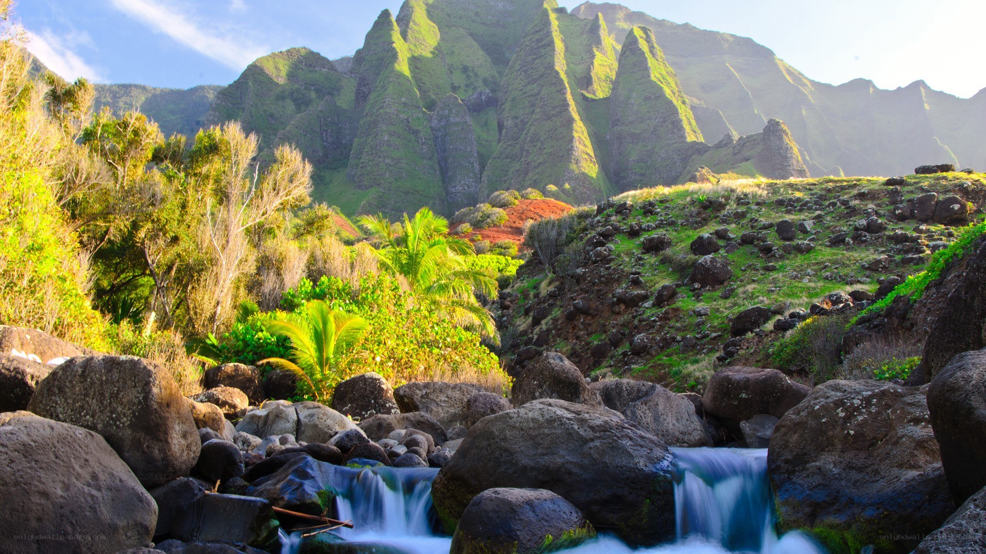 Waterfall in lush mountain valley
