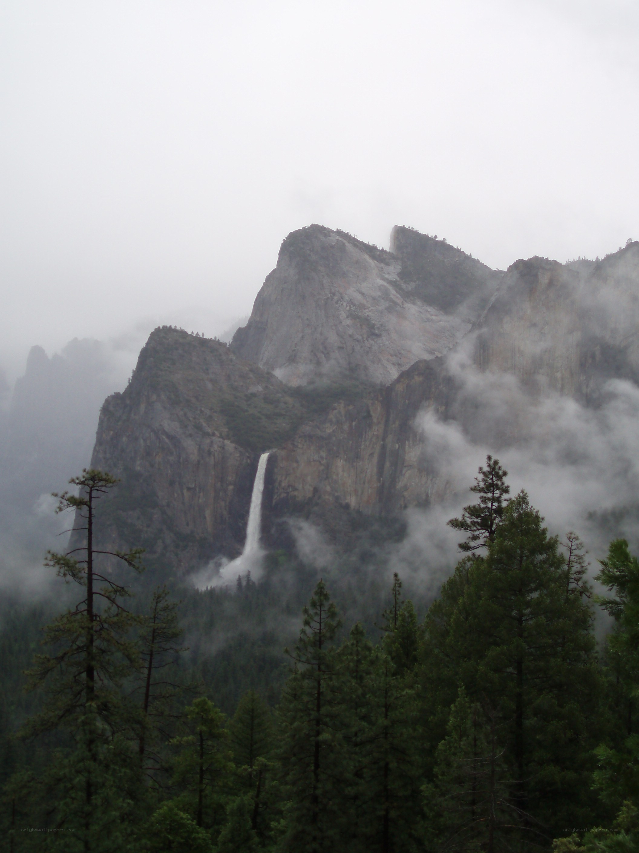 Waterfall in misty mountains