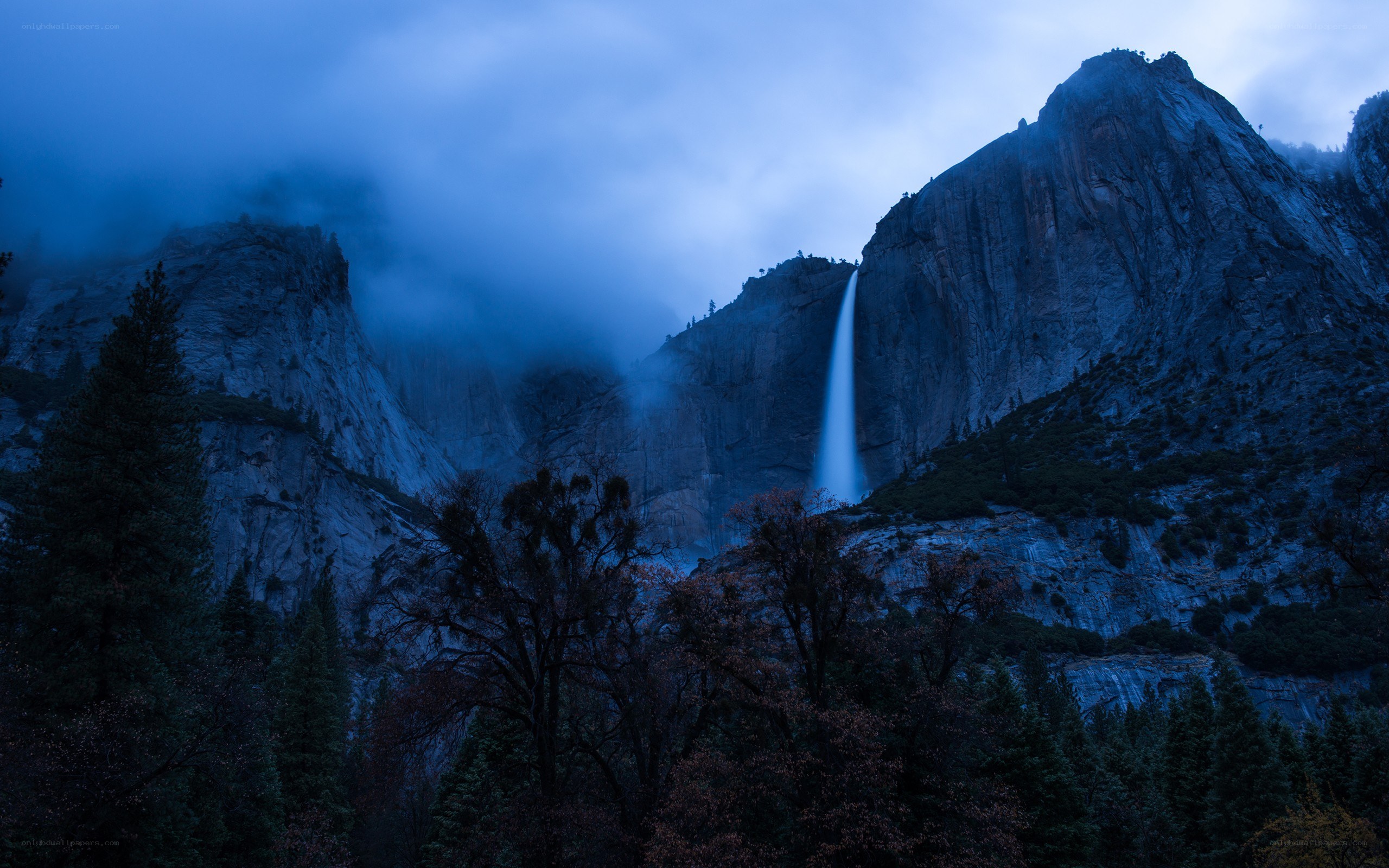 Waterfall in misty mountains