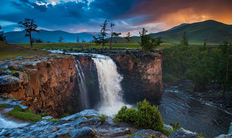 Waterfall in Mountain Valley — Blue, Dramatic, Sunset, Photograph, Mountains, Trees, River, Cliff
