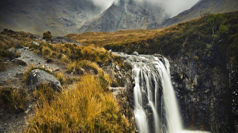 Waterfall in Mountain Valley — Brown, Dramatic