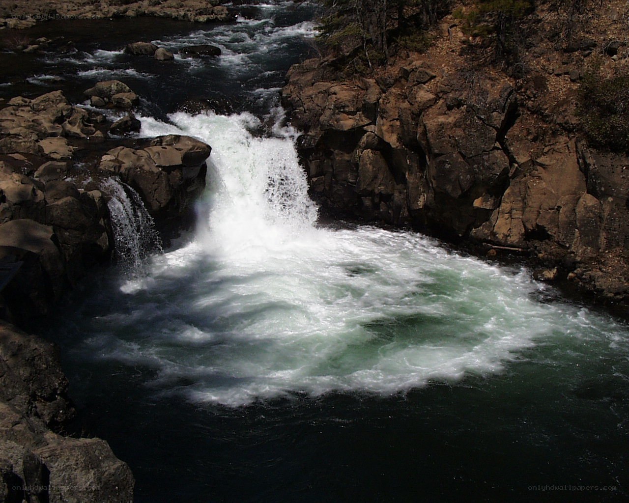 Waterfall in rocky river canyon