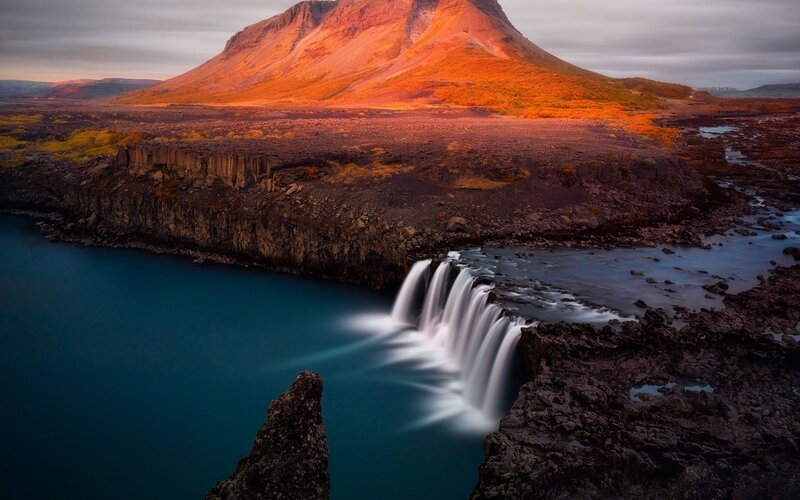 Waterfall in Volcanic Landscape — Orange