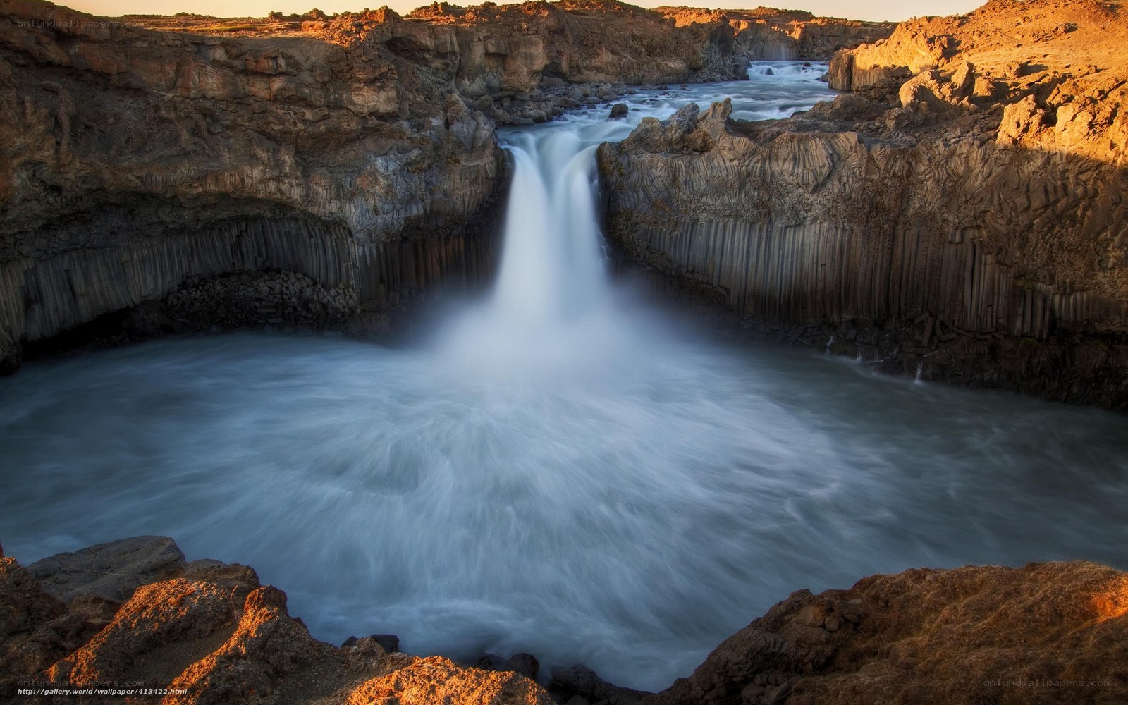 Waterfall in volcanic rock canyon