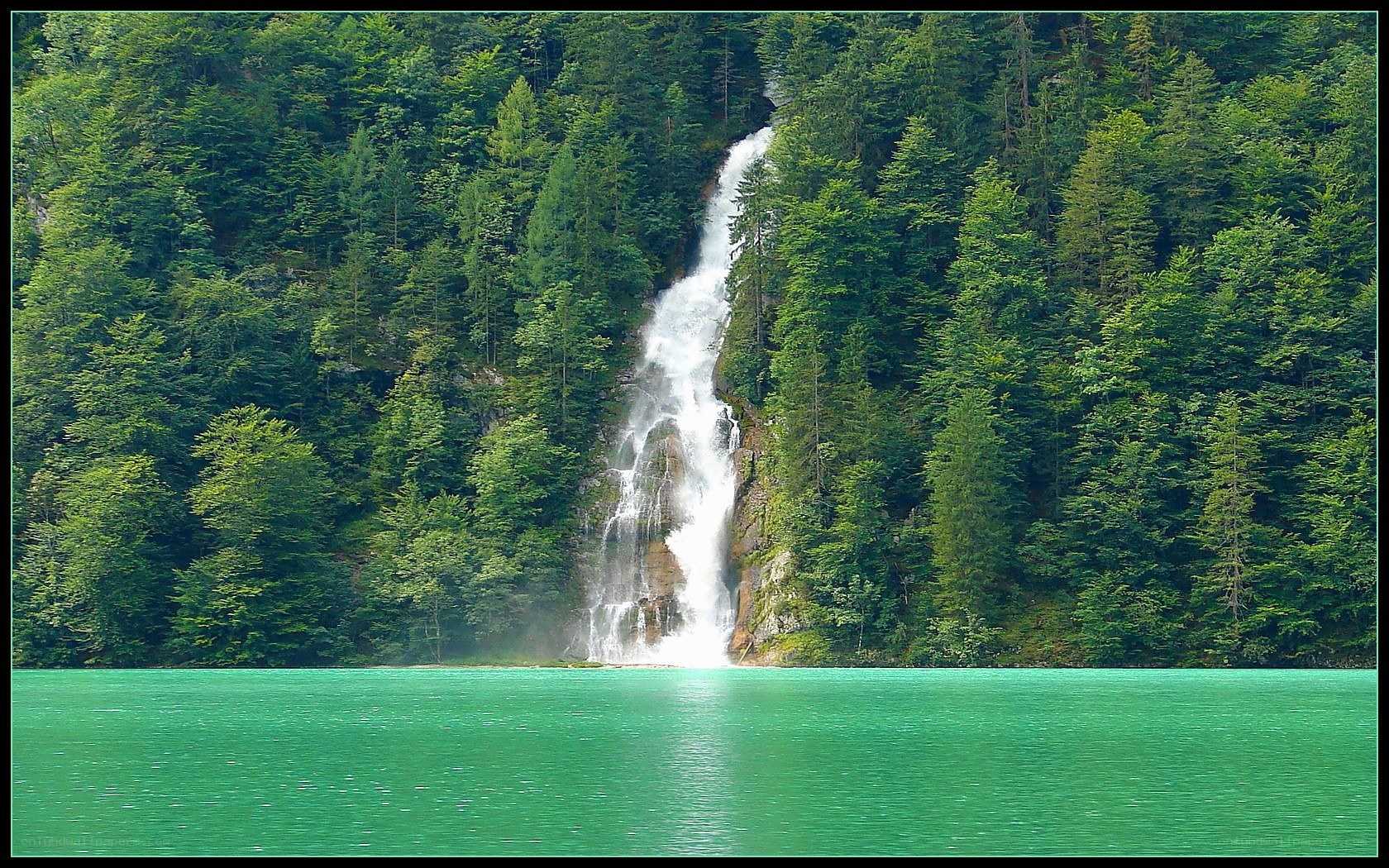 Waterfall into turquoise lake