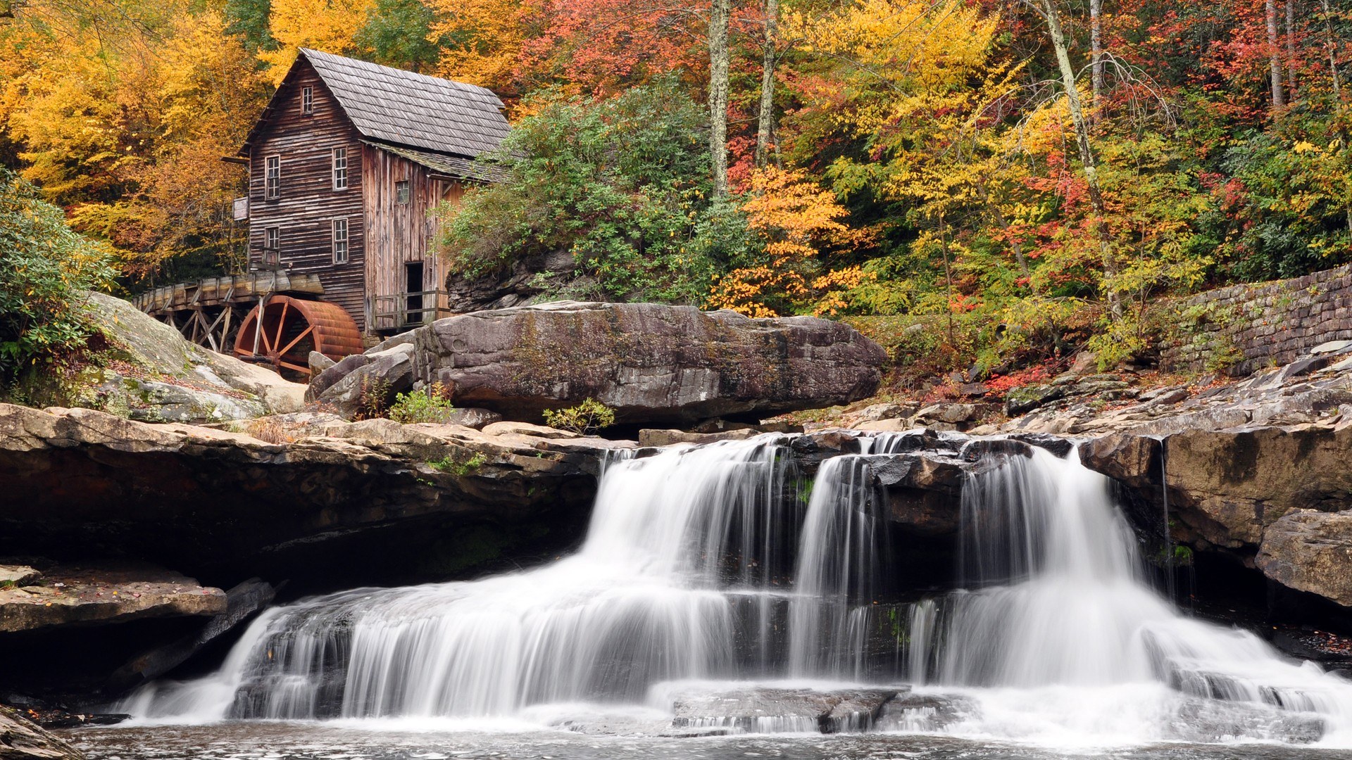 Waterfall mill in autumn forest