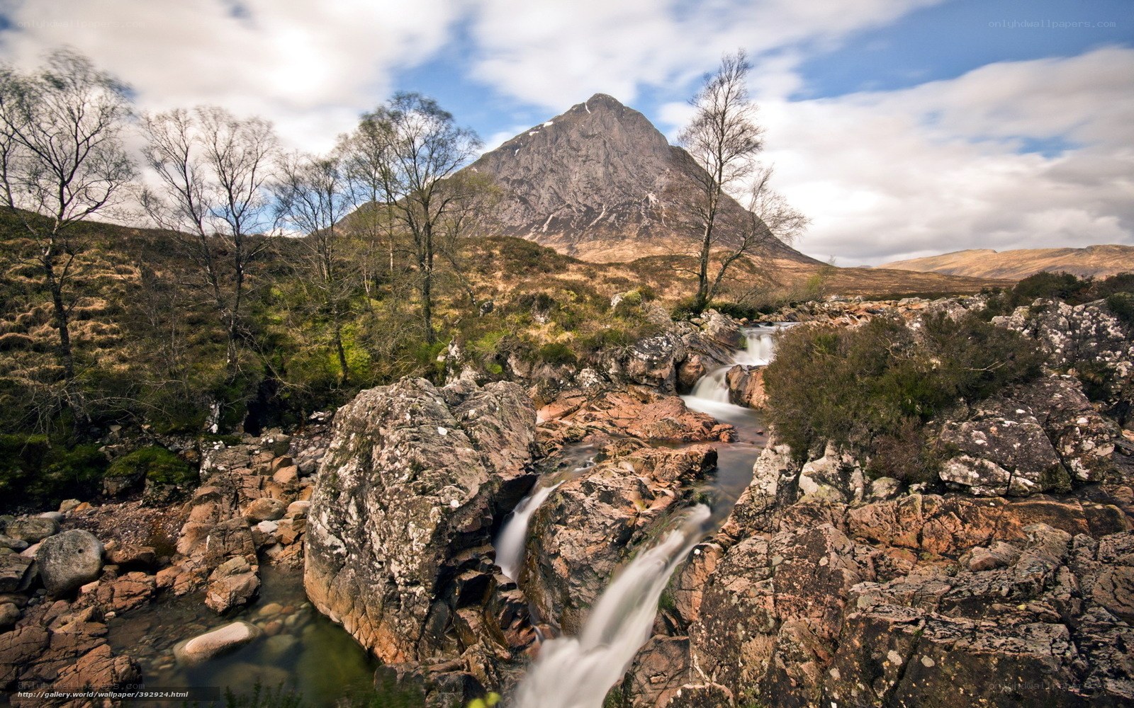 Waterfall near a mountain peak
