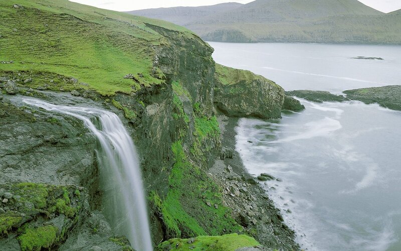 Waterfall on a green cliff