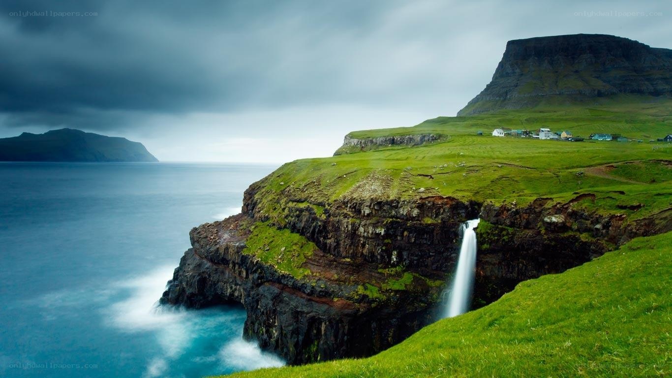 Waterfall on a green cliff