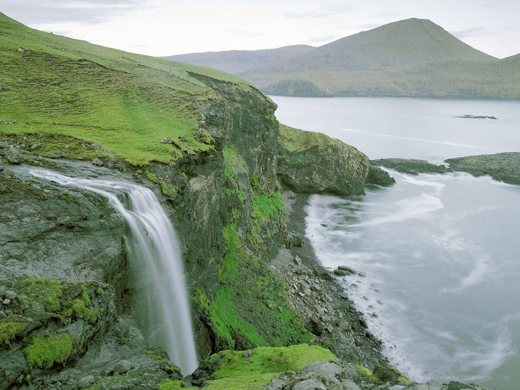 Waterfall on a green cliff