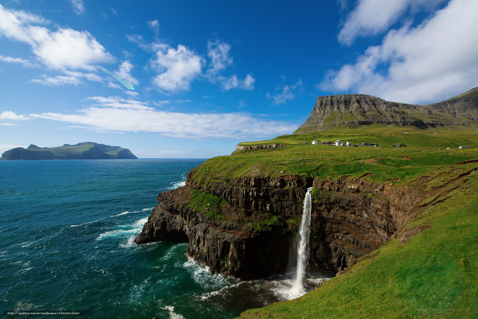 Waterfall on a green cliff