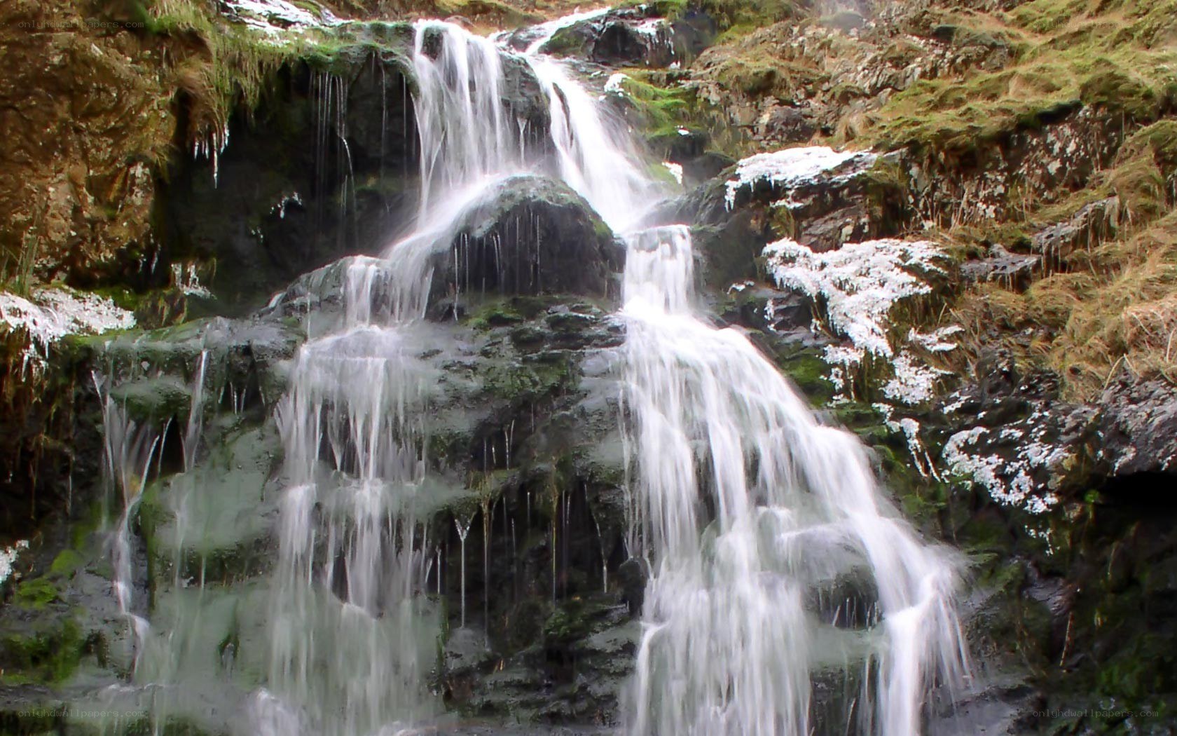 Waterfall on a mossy cliff