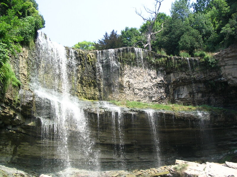 Waterfall on Cliff Face — Green, Serene