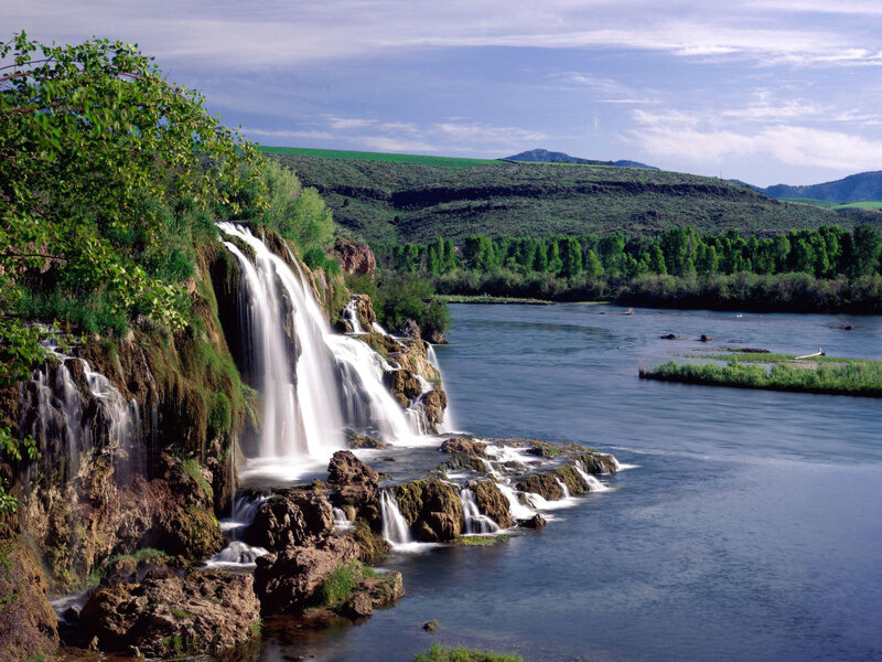 Waterfall on Riverbank — Green, Serene, Afternoon, Photograph, River, Hills, Trees, Blue, Brown
